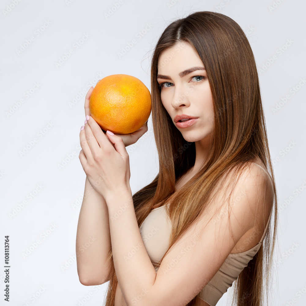 Beautiful Woman with Clean Fresh Skin holding garapefruit Beautiful Woman with Clean Fresh Skin holding garapefruit