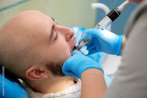 a man at the dentist treats teeth