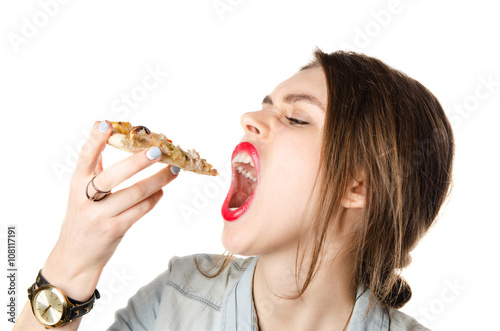 Pretty young sexy woman eating big slice of pizza with big opened mouth standing on white background