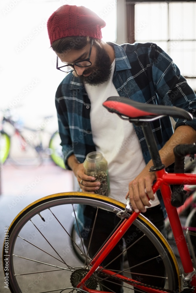 Bike mechanic checking at bicycle Bike mechanic checking at bicycle