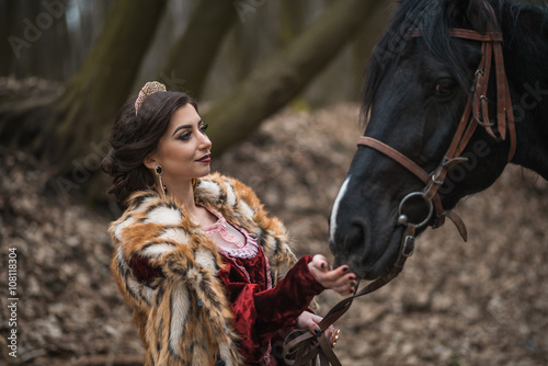 Princess with her horse in the woods © stelmaht