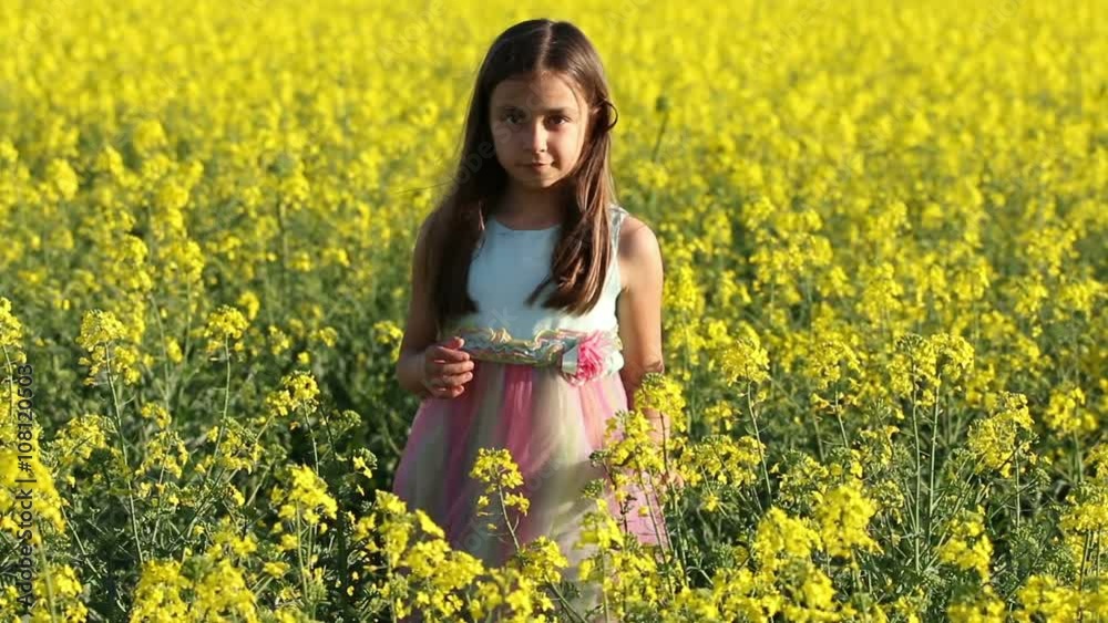 Happy Beauty young girl playing in yellow rape field in rural countryside. Portrait shot, Happy Freedom outdoors concept. Happy Beauty young girl playing in yellow rape field in rural countryside. Portrait shot, Happy Freedom outdoors concept.