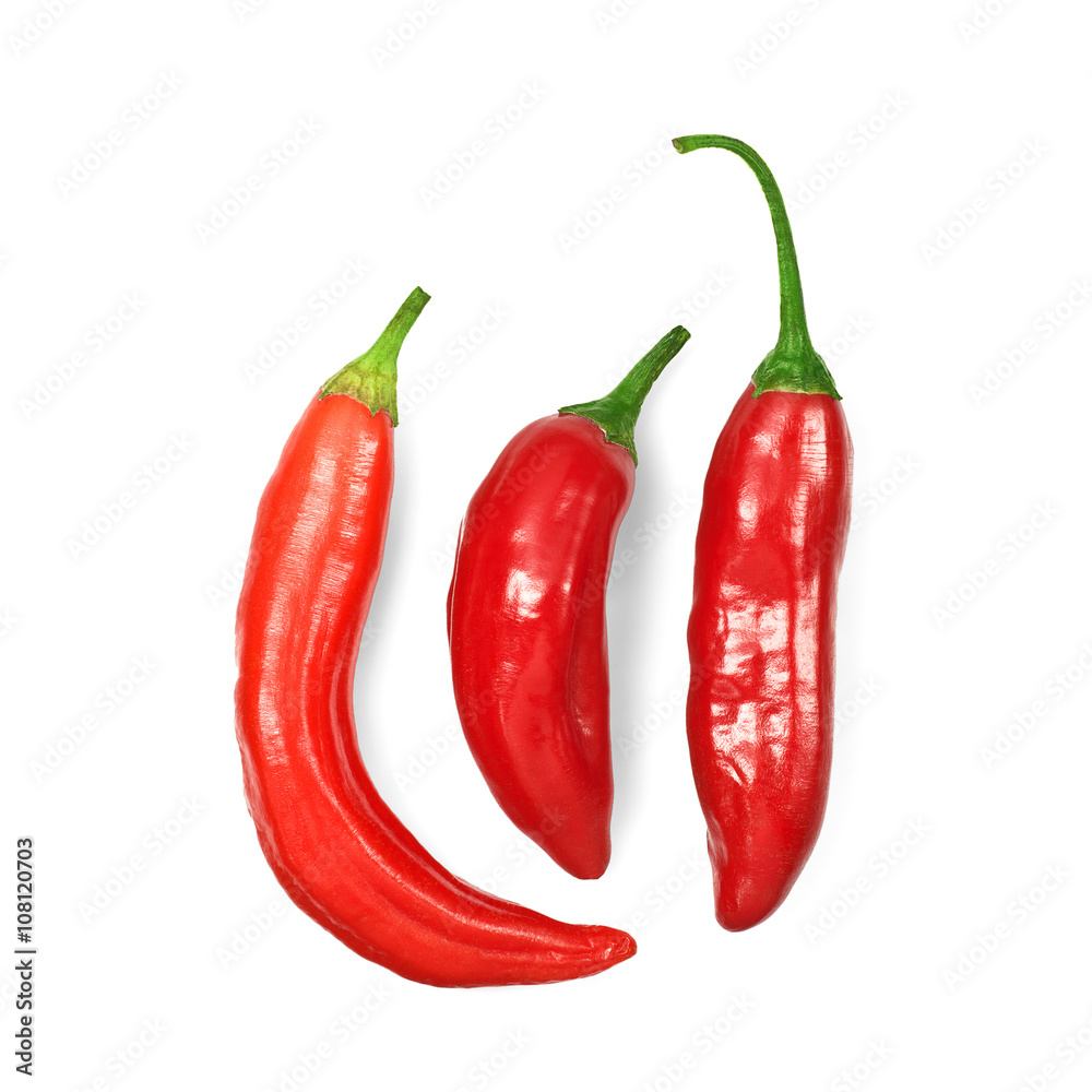 Three red hot chili peppers on white