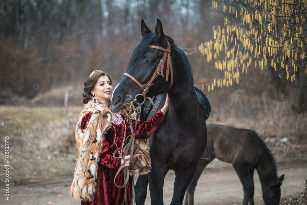 Obraz premium Princess with her horse in the woods