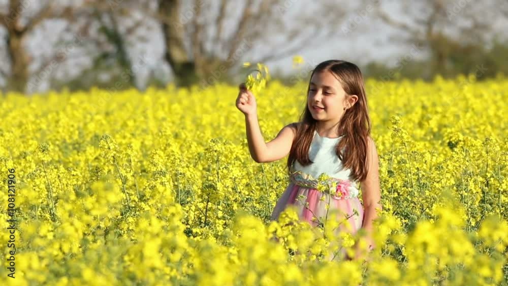 Happy Beauty young girl playing in yellow rape field in rural countryside. Portrait shot, Happy Freedom outdoors concept. Happy Beauty young girl playing in yellow rape field in rural countryside. Portrait shot, Happy Freedom outdoors concept.