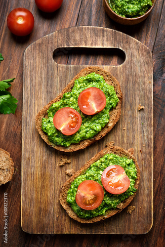 Appetizer pesto sauce and tomatoes on bread
