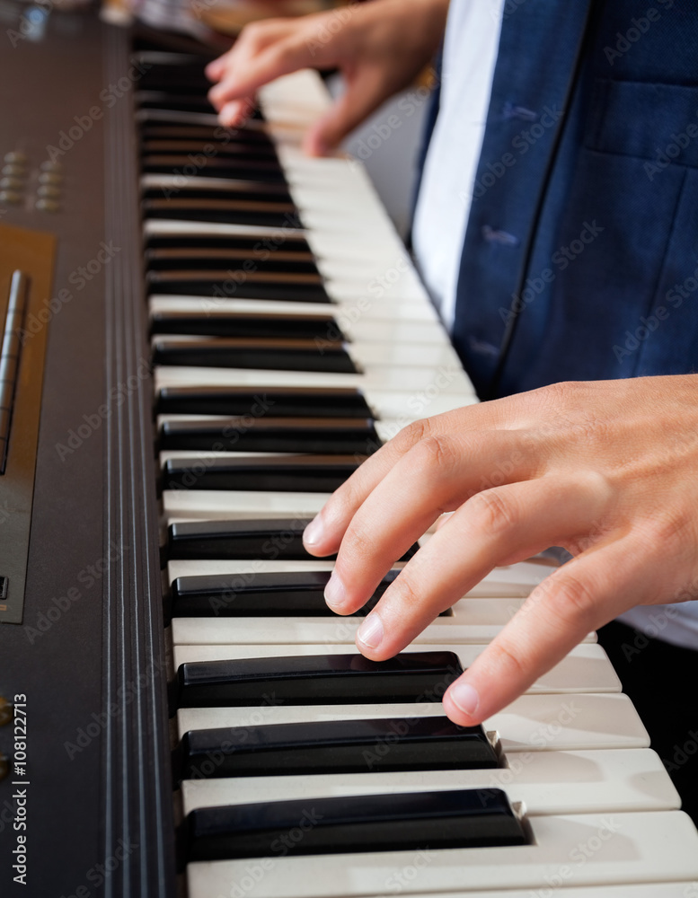 Man's Hands Playing Piano In Recording Studio Man's Hands Playing Piano In Recording Studio