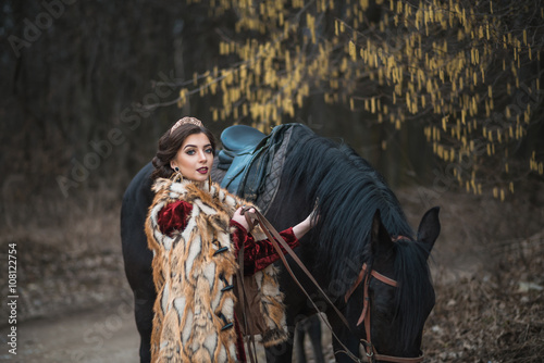 Princess with her horse in the woods