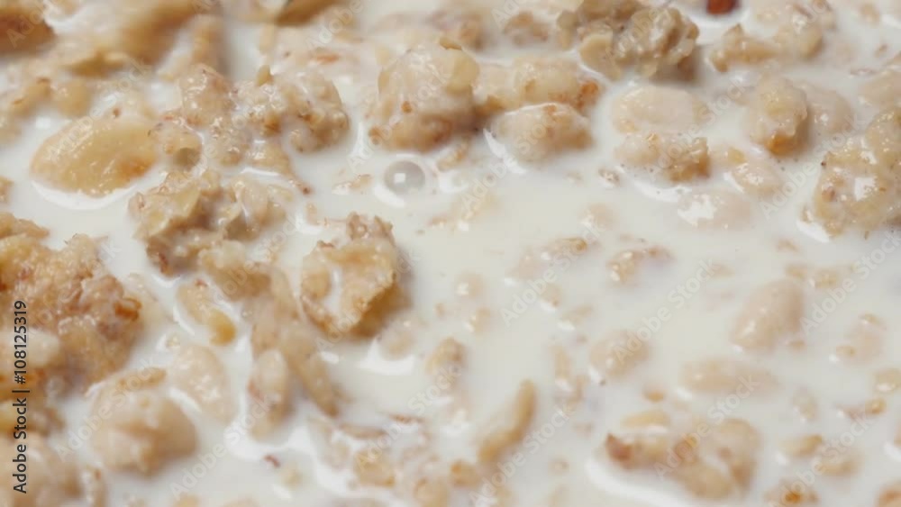 Tasty crunch muesli breakfast with milk in the bowl slow tilt 4K 2160p 30fps UltraHD video - Tilting on cereal food meal mixed with milk 4K 3840X2160 UHD tilting footage Tasty crunch muesli breakfast with milk in the bowl slow tilt 4K 2160p 30fps UltraHD video - Tilting on cereal food meal mixed with milk 4K 3840X2160 UHD tilting footage