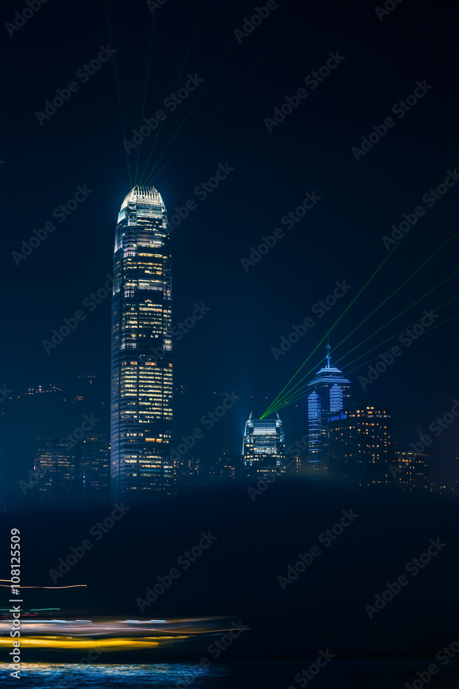 Hong Kong Night View / Illuminated city skyline detail at night with foggy cloud in foreground and lights of passing ship (long exposure) Hong Kong Night View / Illuminated city skyline detail at night with foggy cloud in foreground and lights of passing ship (long exposure)