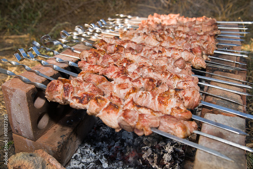 Meat is fried on charcoal on a picnic photo
