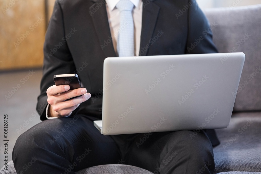 Businessman using laptop and mobile phone Businessman using laptop and mobile phone