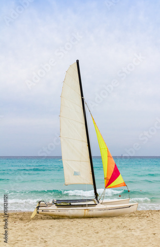 Small sailing catamaran on beach