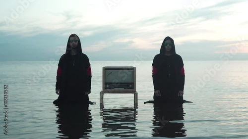 Two Mans With Radioreceiver In The Sea photo