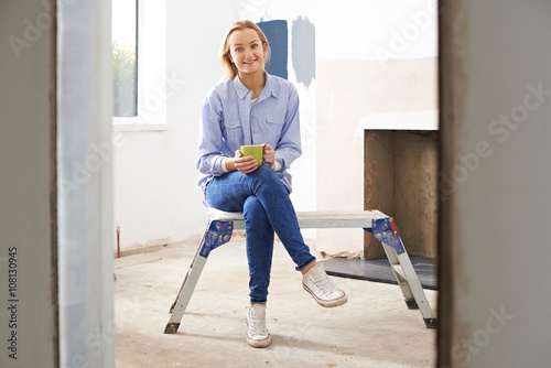 Woman Sitting In Property Being Rennovated photo