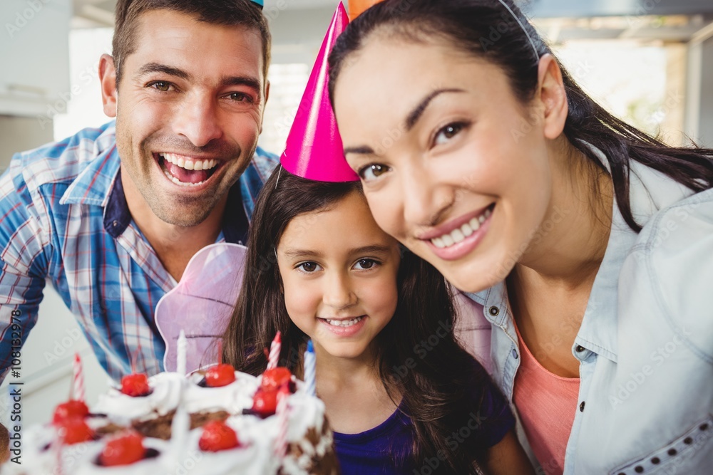 Portrait of cheerful family celebrating birthday at home Portrait of cheerful family celebrating birthday at home