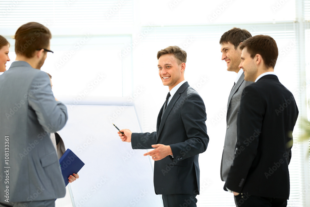 Workers at business meeting looking at presentation of financial reports in modern office Workers at business meeting looking at presentation of financial reports in modern office