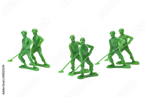 a pair of green military toy soldiers