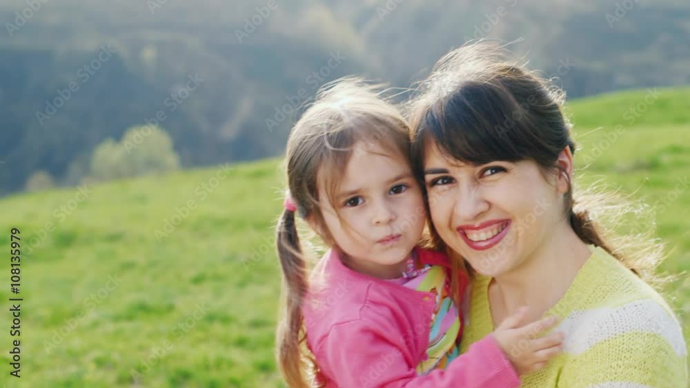 Young mother hugging her daughter three years Young mother hugging her daughter three years