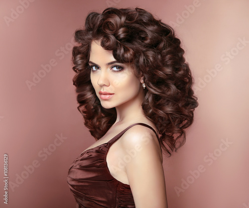 Healthy hair. Beautiful young smiling woman with long curly hair