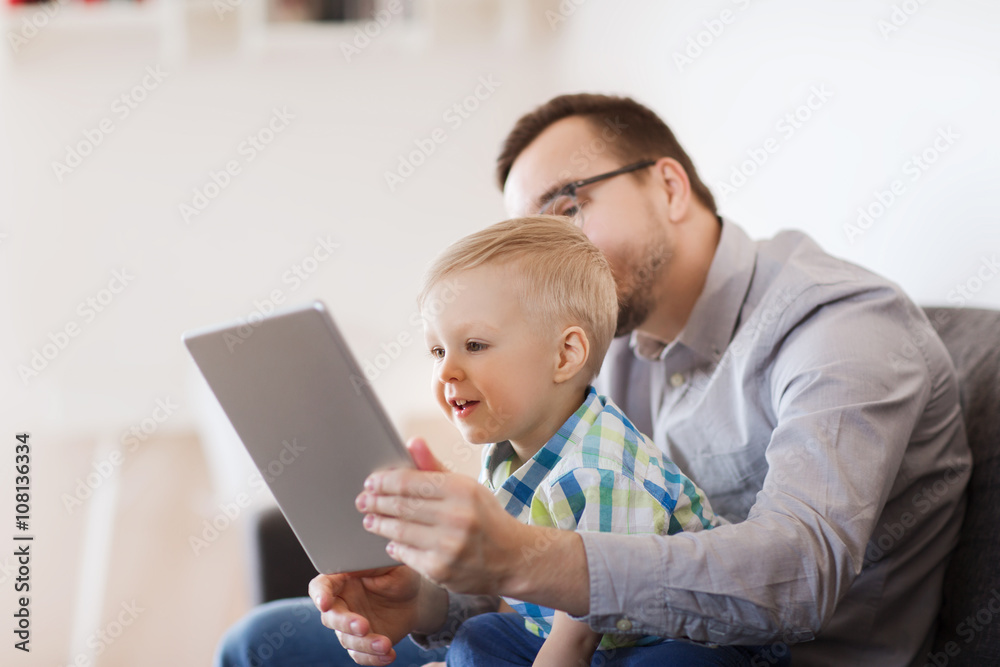 father and son with tablet pc playing at home father and son with tablet pc playing at home