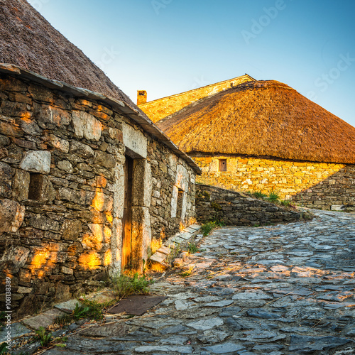 O Cebreiro, Spain. Historic stone huts at sunset photo