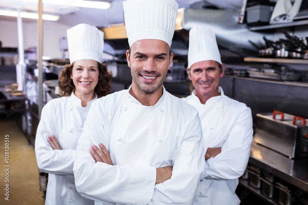 Team of chefs standing with arms crossed