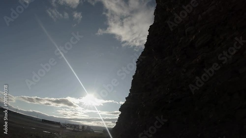Stony Hill Under Rays of Sunand Small Clouds in Blue Sky photo