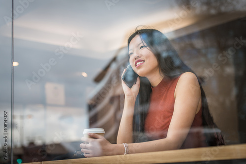Photography Young woman sitting at cafè and talk to the phone