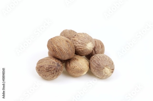 Dried nutmeg seeds, on white background