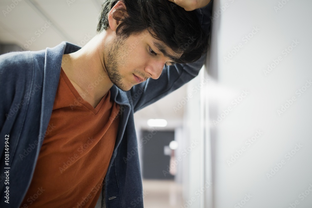 Worried student leaning on wall Worried student leaning on wall