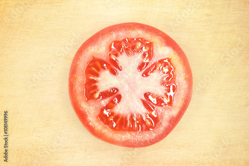 sliced tomato on wooden cutting board