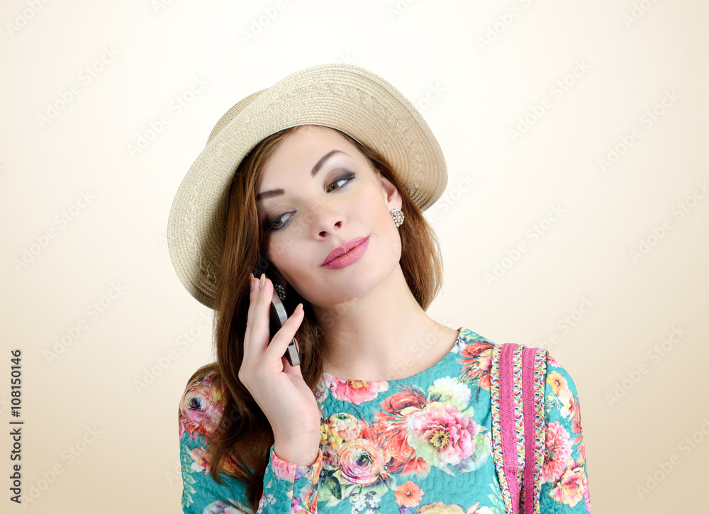 Young girl in hat with a cellphone in his hand