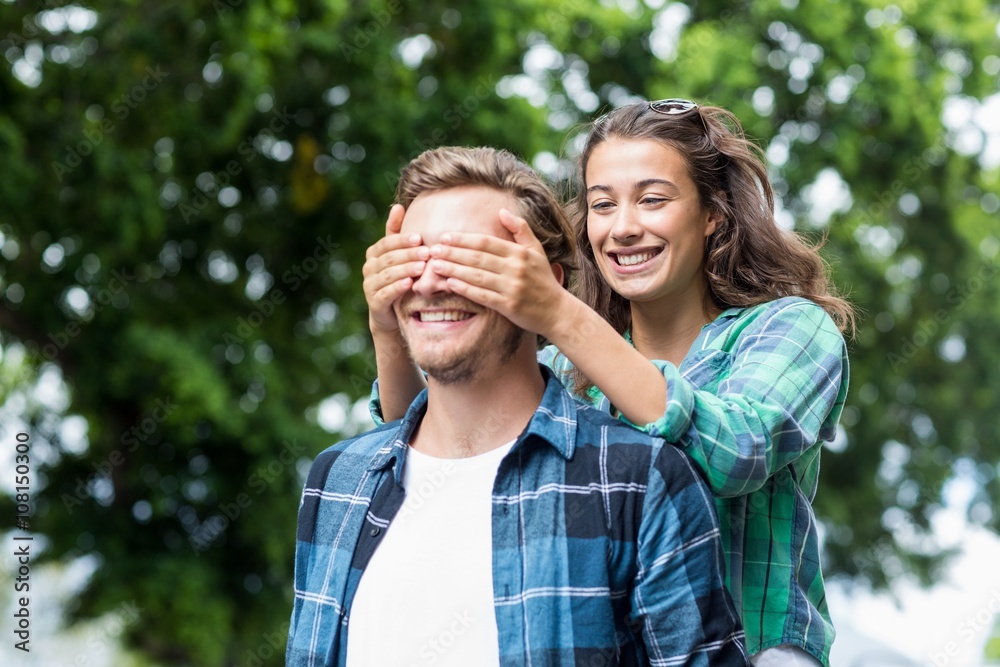 Woman covering her mans eyes Woman covering her mans eyes