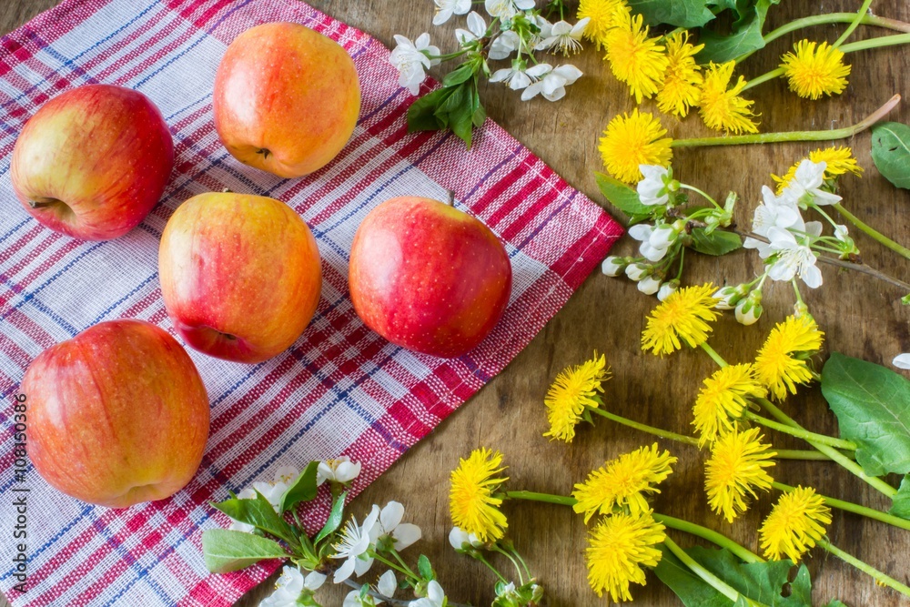 Big juicy red apples near the flowers Big juicy red apples near the flowers