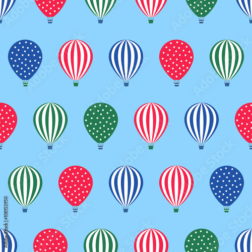 Hot air balloon seamless pattern. Baby shower vector illustration on blue sky background. Polka dots and stripes. Colorful hot air balloons design.