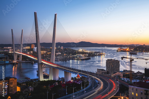 Panorama of Vladivostok at sunset, Far East Russia. Golden bridge. photo