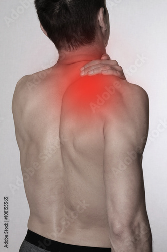 Man with pain in shoulder / back. Pain relief, chiropractic concept