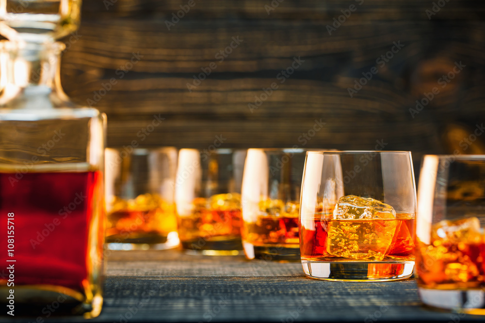 selective focus glass of cold whiskey on wooden-table selective focus glass of cold whiskey on wooden-table