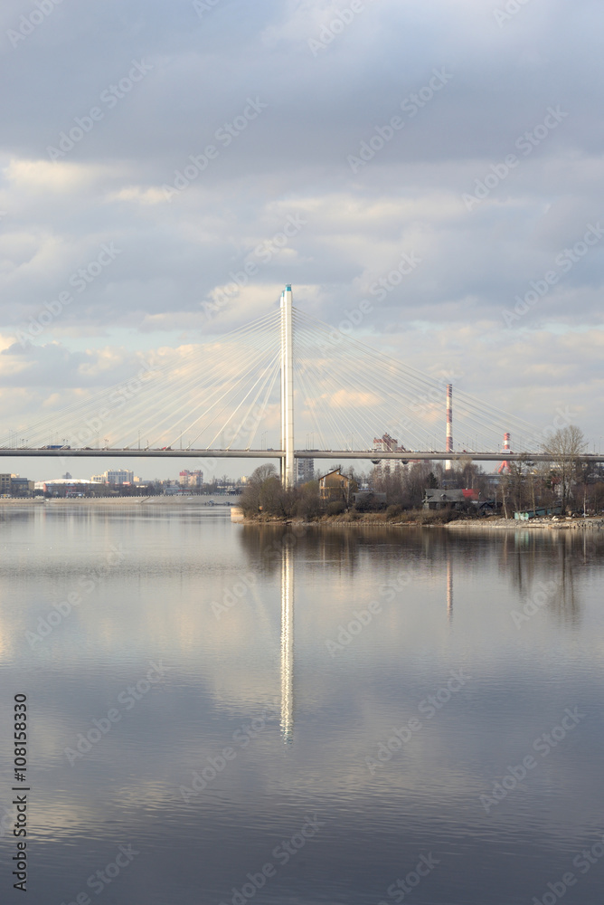 Cable stayed bridge and Neva river on the outskirts of St. Petersburg at cloud spring day, Russia.