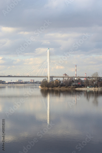 Cable stayed bridge and Neva river on the outskirts of St. Petersburg at cloud spring day, Russia.