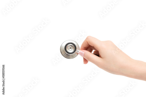 Female hand holds stethoscope on a white background.