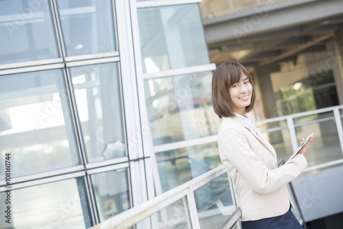 Attractive asian business woman working on tablet computer outsi Free Download Attractive asian business woman working on tablet computer outsi - GFXLoad