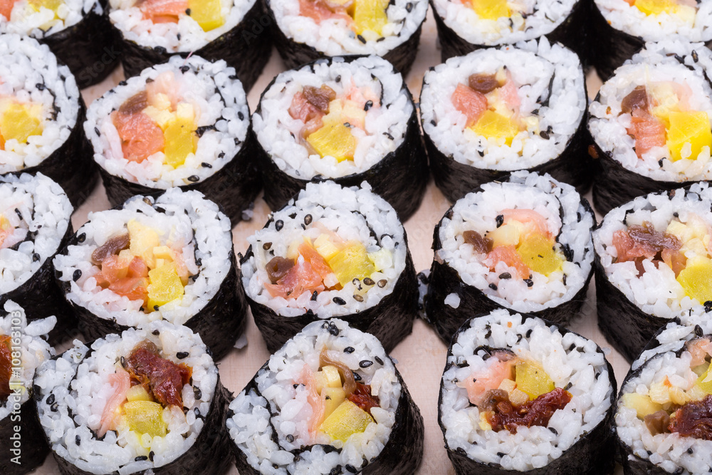 sushi fresh maki rolls isolated on wooden board sushi fresh maki rolls isolated on wooden board