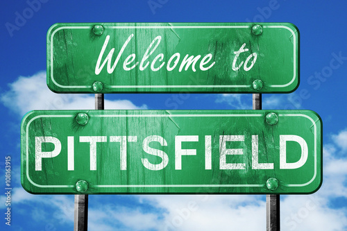 pittsfield vintage green road sign with blue sky background photo