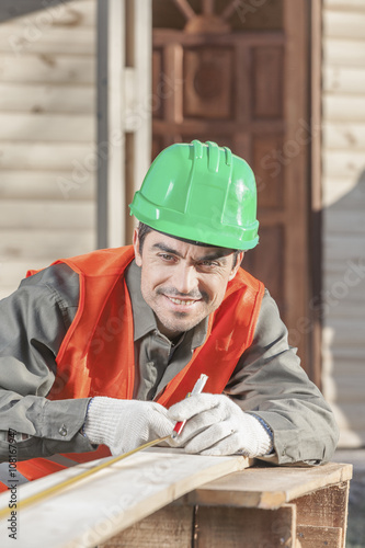 Contractor measuring a cut