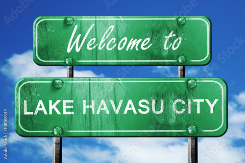 lake havasu city vintage green road sign with blue sky backgroun photo