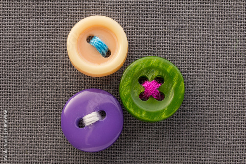 buttons on gray fabric in macro