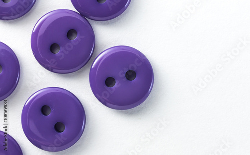purple buttons on a white background in macro