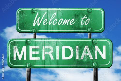 meridan vintage green road sign with blue sky background photo